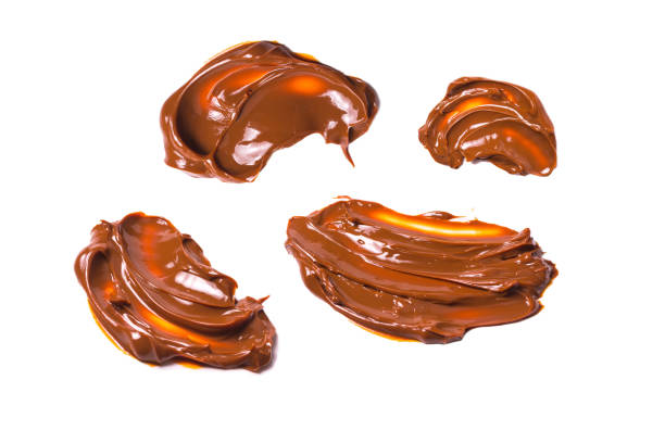 istock Melted tasty caramel splashes isolated on white background. 1437974070