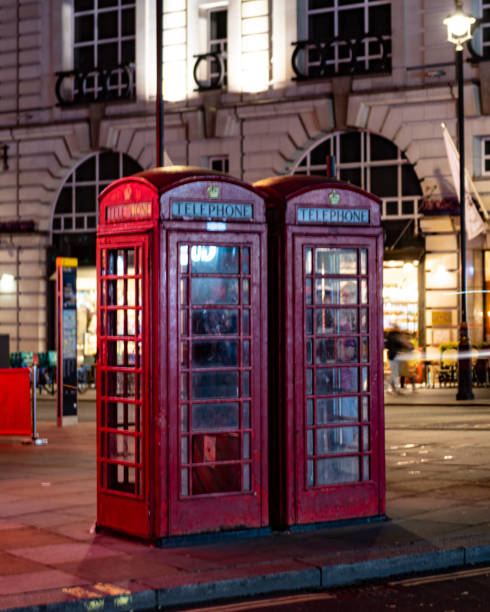istock Red telephone booth at night 1437975321