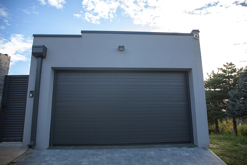 The modern garage door of a beautiful building on a sunny day