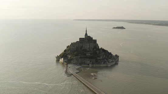Aerial view of breathtaking Mont-Saint-Michel located, Normandy, France. Top view of an amazing castle on the island surrounded by the sea.