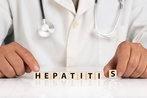 Doctor and cubes with text HEPATITIS