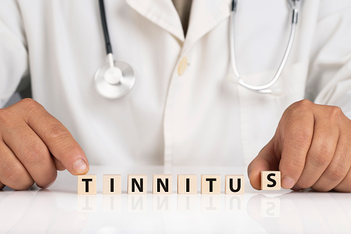 Doctor and cubes with text TINNITUS