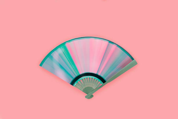 Top view of compact disc made fan with rainbow reflections on isolated pink background. Creative, retro, abstract, music concept. Light diffraction into iridescent pink-blue-purple-green spectrum. Top view of compact disc made fan with rainbow reflections on isolated pink background. Creative, retro, abstract, music concept. Light diffraction into iridescent pink-blue-purple-green spectrum. cd player stock pictures, royalty-free photos & images