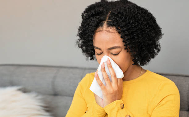 istock Woman Blowing Nose 1437980529