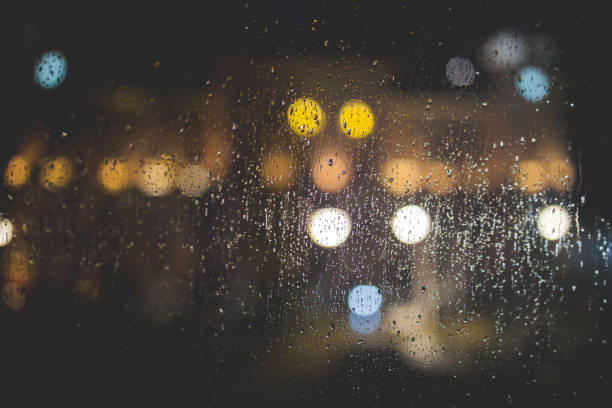 istock Raindrops on a glass with bokeh lights on a blurry background 1437980572