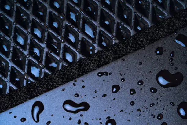 New all season, all weather black car mat detail with water drops.