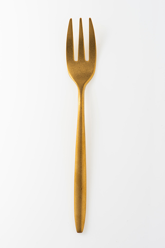 Golden fork isolated on white background.Studio shot.