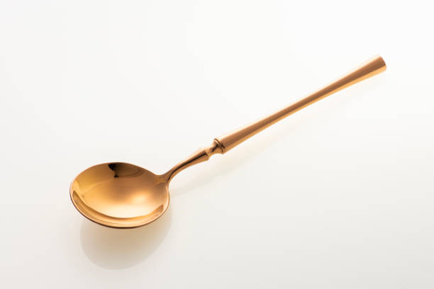 istock Golden spoon isolated on white background. Studio shot. 1437981146