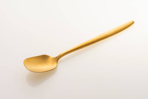istock Golden spoon isolated on white background. Studio shot. 1437981147