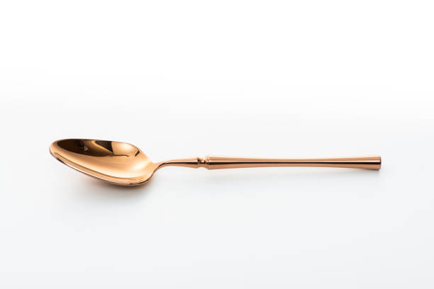 istock Golden spoon isolated on white background. 1437981149