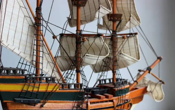 Wooden Model Of A Masted Ship With Sails On The Masts On White Background