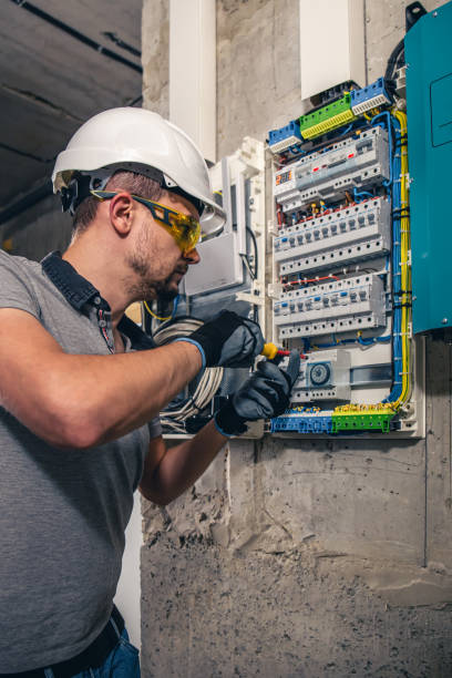 istock Man, an electrical technician working in a switchboard with fuses. 1437984434