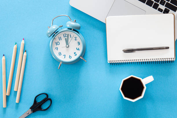 istock Flat lay, alarm clock and stationery items on a blue background. 1437984869
