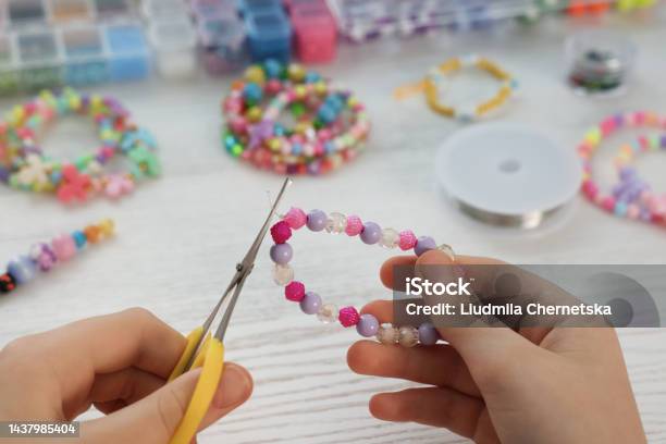 Girl Making Beaded Jewelry At White Wooden Table Closeup Stock Photo - Download Image Now