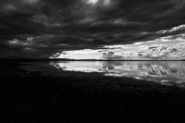 istock Perfectly symmetric clouds reflections on a lake 1437986591