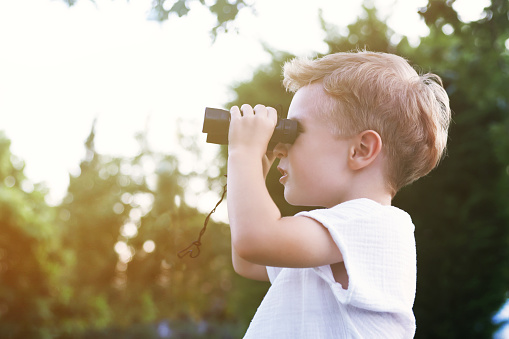 Happy Boy looks through the binoculars