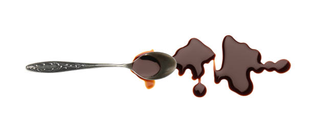 istock Spilled soy sauce and spoon on white background, top view 1437988067