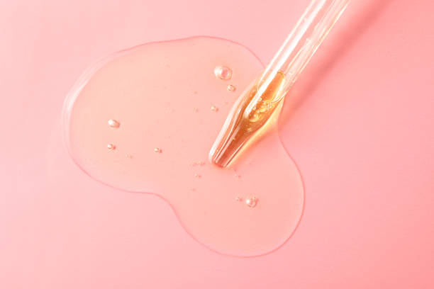 istock Dripping hydrophilic oil from pipette on pink background, top view 1437989333