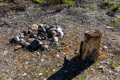 Rock fire pit and wooden stump