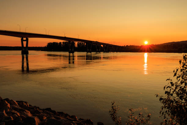 istock Bridge over river during beautiful orange sunset 1437989573