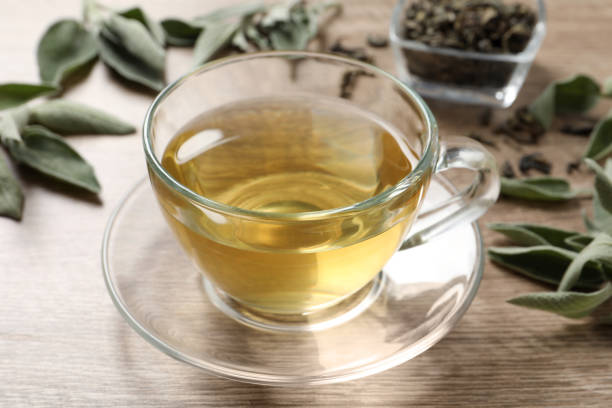 istock Cup of aromatic sage tea on wooden table 1437989588
