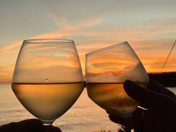 istock Toasting a Sunset horizon in wineglass 1437993263