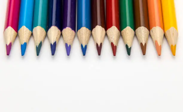 Photo of Colored pencils on a white background. Education concept.