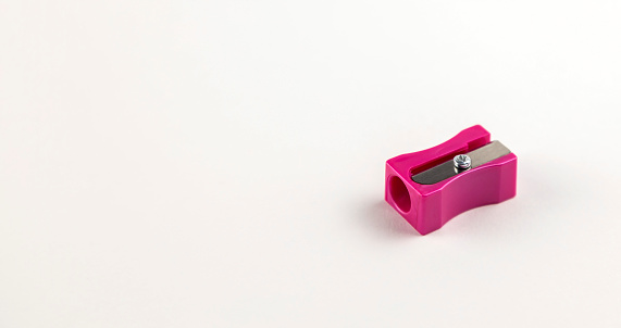 Sharpener for pencils of pink color on a white background