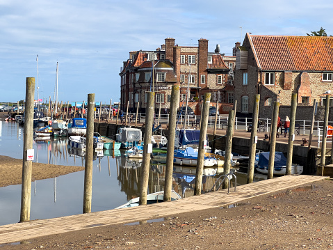Blakeney, United Kingdom - Octobeer 13th 2022: View of the tidal harbour and quay in the north Norfolk village of Blakeney, UK.
