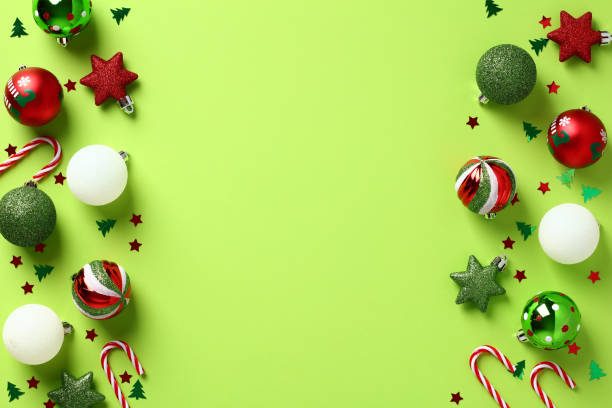istock Green Christmas background. Frame borders made of baubles, Xmas decorations, candy canes, confetti. Flat lay, top view, copy space. 1437997208
