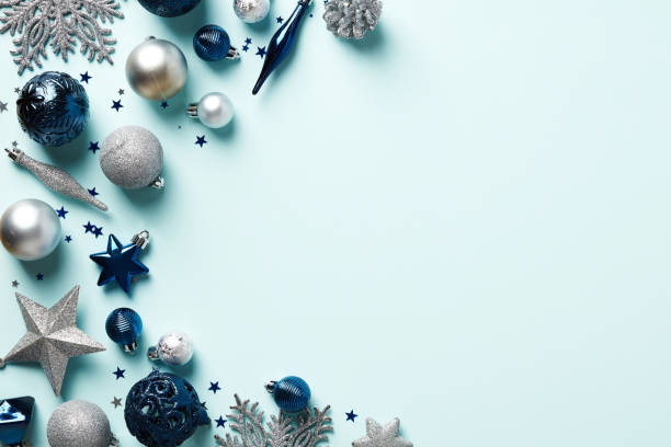 istock Merry Christmas light blue background with silver and dark blue baubles, stars, decorations, confetti. Happy New Year banner, frame, greeting card template. Winter holidays seasonal background. 1437997589
