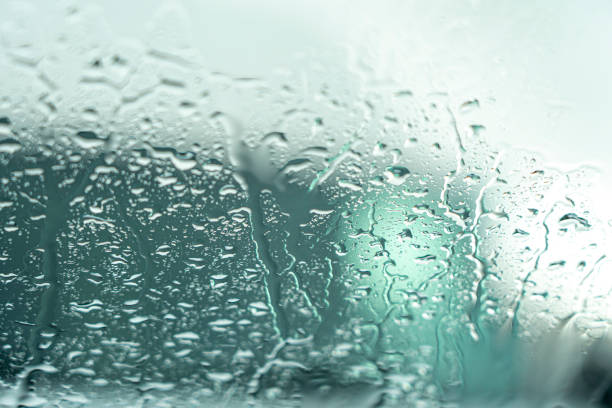 istock drops of rainwater running down glass 1437998331