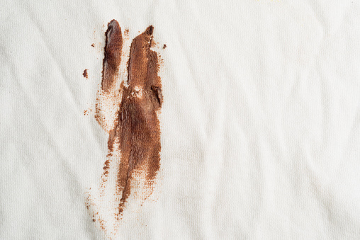 Macrophotography of chocolate stain or dirt on T-shirt.