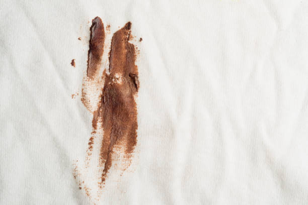 Chocolate stain on T-shirt Macrophotography of chocolate stain or dirt on T-shirt. texture of dirty cotton fabric stock pictures, royalty-free photos & images