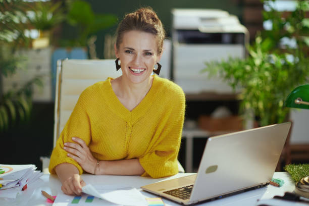 business owner woman in green office working with documents