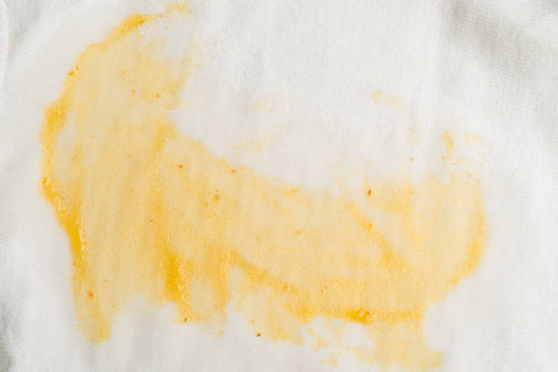 Macro photography of mustard stain on white fabric of cotton