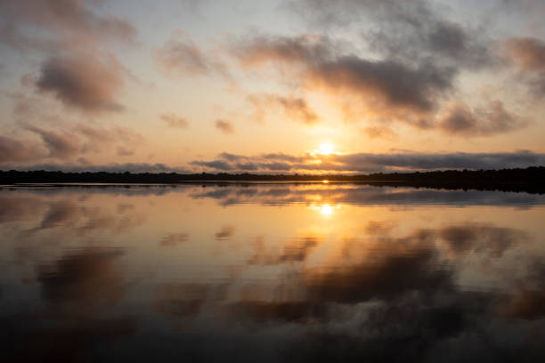 istock Beautiful view to sunrise and clouds over river 1438003039