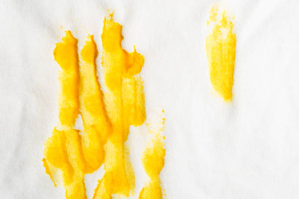 istock Mustard stain on white T-shirt 1438003113