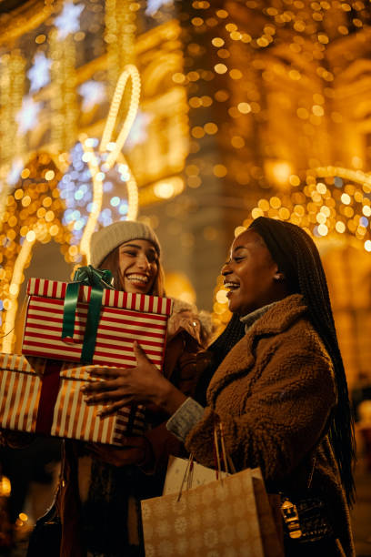 istock Two beautiful women at winter shopping 1438003459