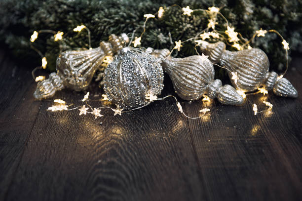 istock Christmas ornaments with golden lights dark background 1438004777