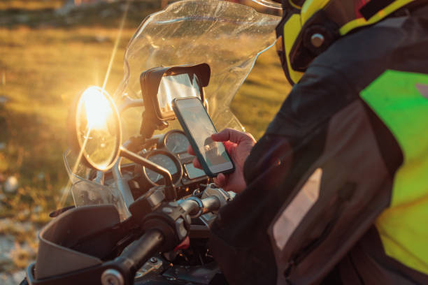istock Biker searching road on global positioning system on phone 1438006759