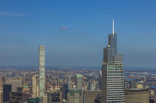 Beautiful view of densely built-up Manhattan on blue sky background. USA.