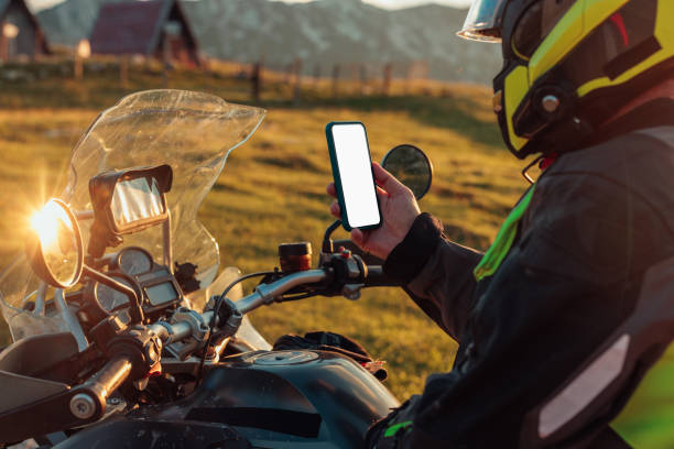 istock Biker holding his phone, using app to find the best route 1438008025