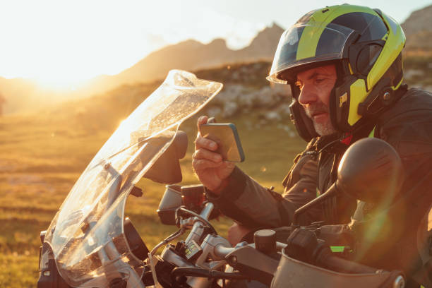 istock Biker searching global positioning system on smart phone 1438009021
