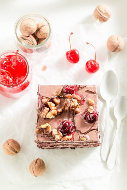 Tasty and homemade chocolate cake with cherries and nuts
