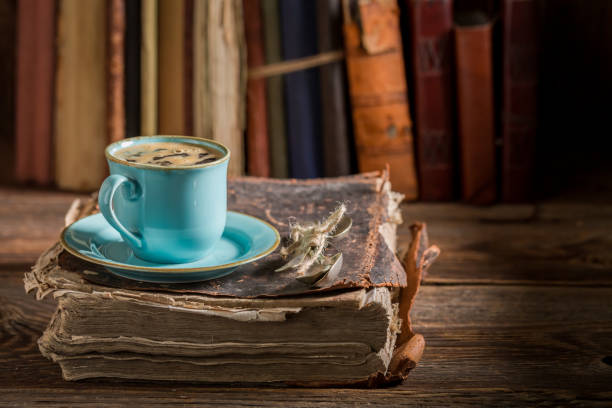 istock Coffee in blue porcelain in library on old book 1438011362