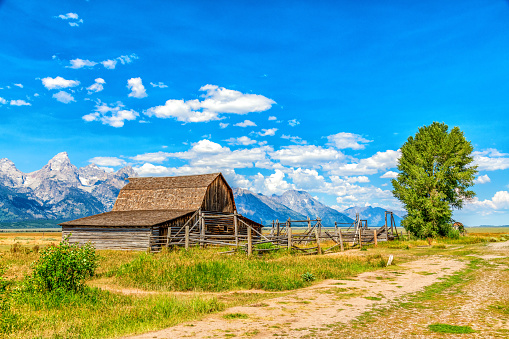 The Moulton Barn, a publicly owned national landmark along the Mormon Row Historic District in Grand Teton National Park, Wyoming with the peaks of the Teton Range in the background.  This barn, the John Moulton Barn is commonly dubbed the worlds second most photographed barn next to the T.A. Moulton Barn located just down the street.  Either way, the barns on Mormon Row are the most photographed in the world.