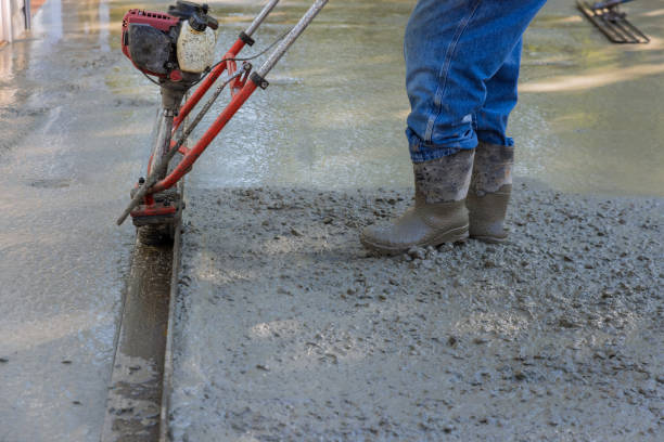 istock It is necessary to use a machine to align fresh concrete compacted layer on a new driveway construction project. 1438018841