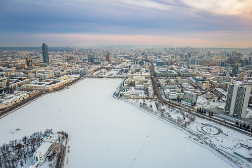 Embankment of central pond and Plotinka in Yekaterinburg at winter sunset. Winter snow-covered city. The historic center of the Yekaterinburg, Russia, Aerial View