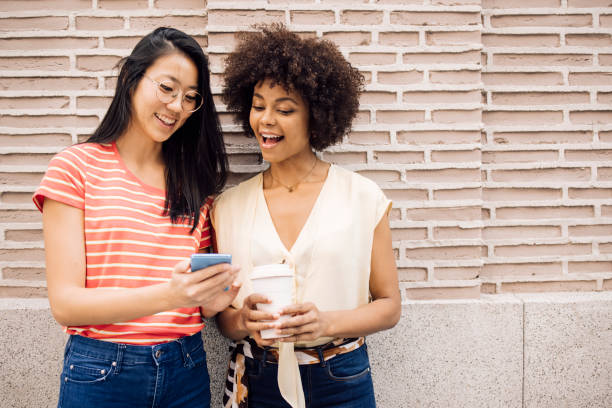 istock Best friends enjoying in Madrid, using smartphone and having fun 1438022982